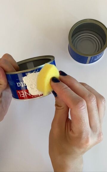 someone is peeling an item from a can