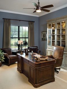 a living room filled with furniture and a ceiling fan