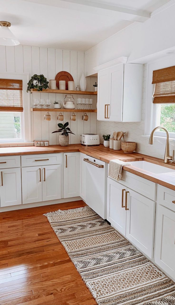 the kitchen is clean and ready for us to use it's white cabinetry