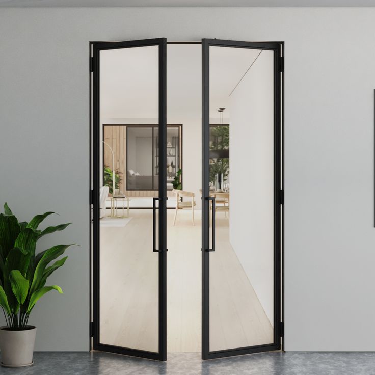 an open door leading to a living room with a potted plant in the corner