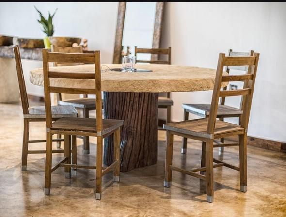 a wooden table with four chairs around it