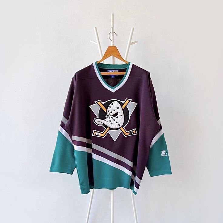 90s Mighty Ducks of Anaheim NHL jerseys/ L * PLEASE READ BEFORE PURCHASE * PLEASE consider the PHOTOS before making the decision * The images may DIFFER in appearance from the actual product because we took pictures under daylight.  * PLEASE send your PHONE NUMBER after your purchase for the shipping company to contact you X No returns X No refund Condition : 9/10 More details : look at the pictures  Brand : Starter Size : L Pit to pit/ Chests : 27/54 inches  Length : 30 inches  Material : polye Anaheim Ducks Jersey, Throwback Crew Neck Jersey With Graphic Print, Ducks Hockey, Mighty Ducks, Nhl Jerseys, Womens Sports, Anaheim Ducks, Hockey Jersey, Shipping Company