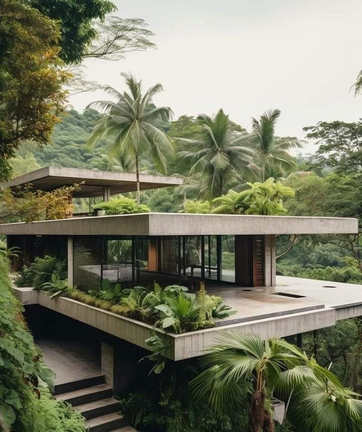 the house is surrounded by lush vegetation and trees