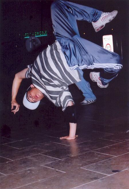 a man is doing a handstand on the floor with his feet in the air