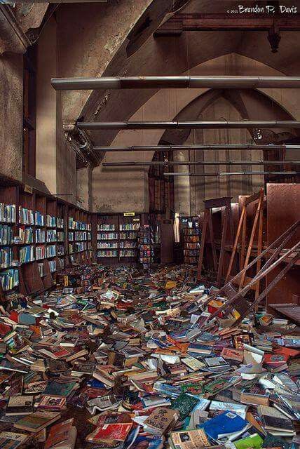 a library filled with lots of books on top of a floor covered in piles of books