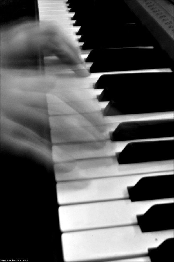 blurry photograph of a person playing the piano