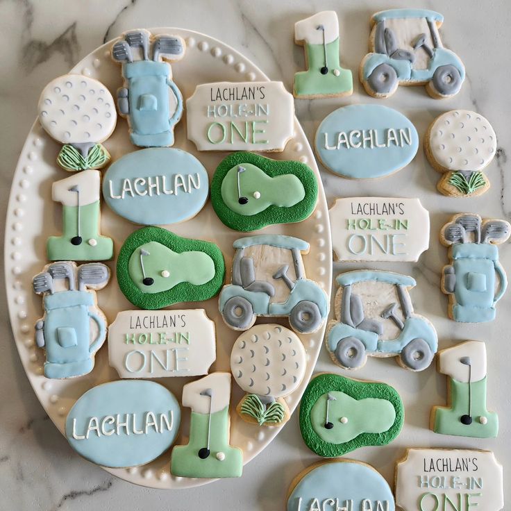 decorated cookies are arranged on a plate with the names of their baby's birth