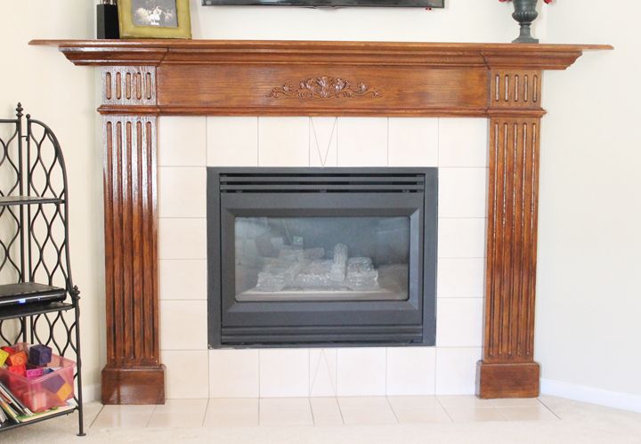 a fireplace in a living room next to a shelf with vases on top of it