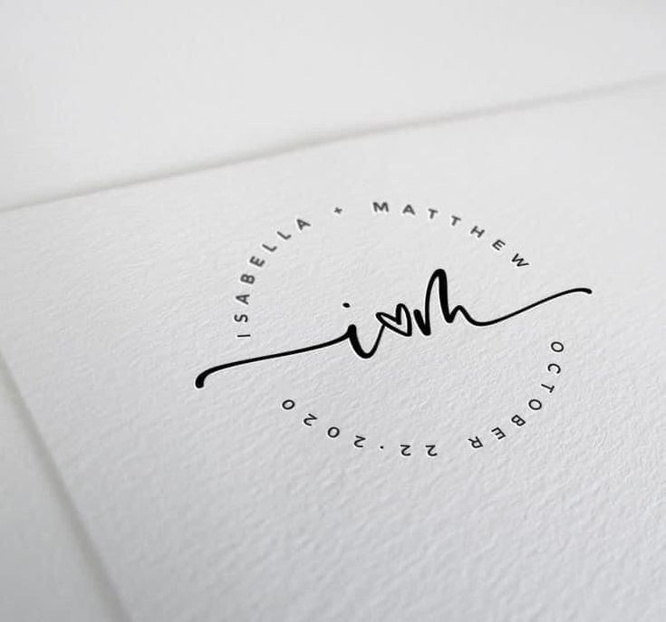 a close up of a white paper with a black ink signature on the front and bottom