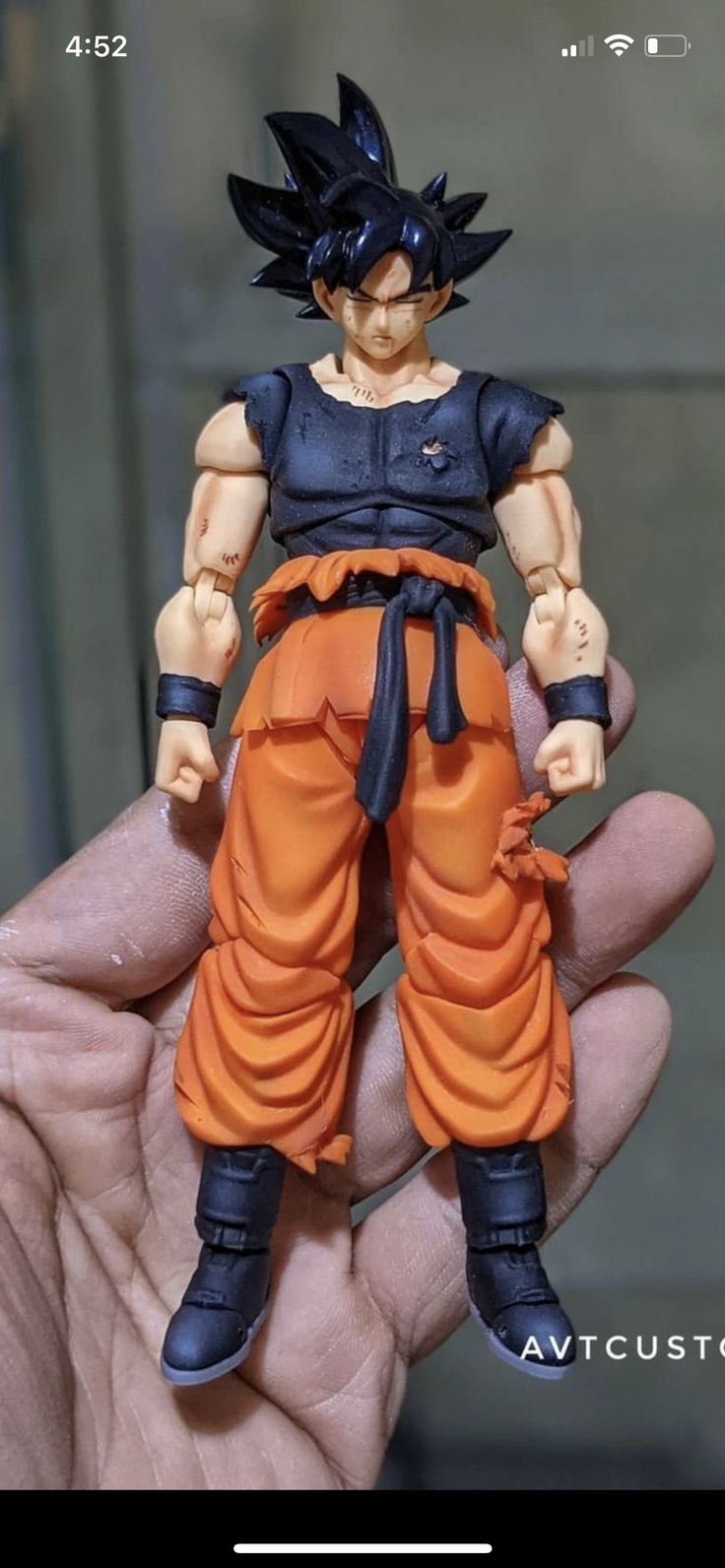 a hand holding a dragon ball figure in it's left hand with the image of gohan