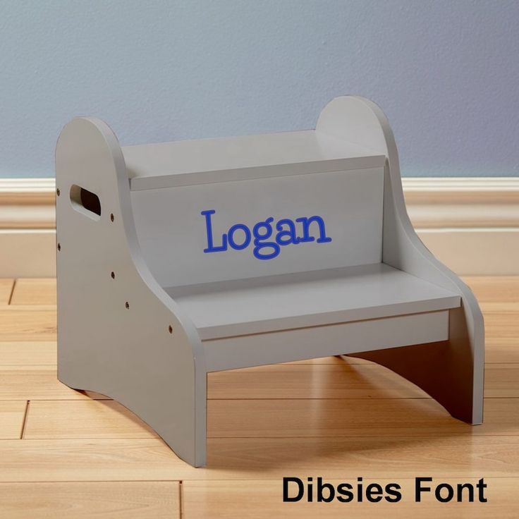 a wooden step stool with the word logan on it's back and side