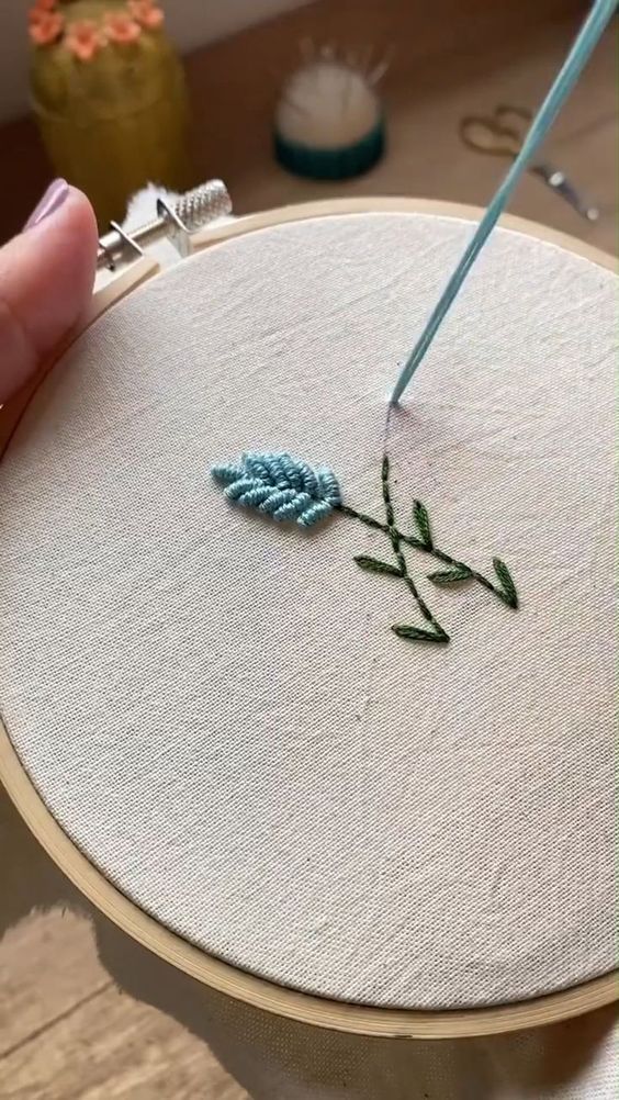 someone is stitching something on the embroidery hoop