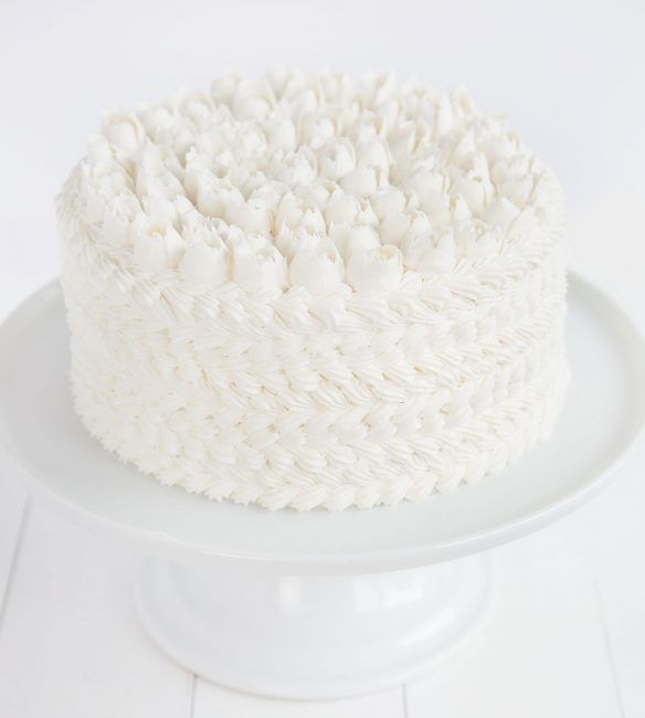 a white cake sitting on top of a white plate