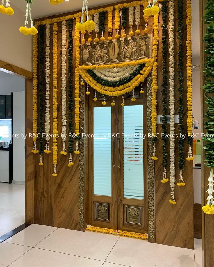 an entrance decorated with flowers and garlands