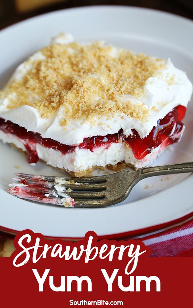 a piece of cake on a white plate with a fork and crumbled topping