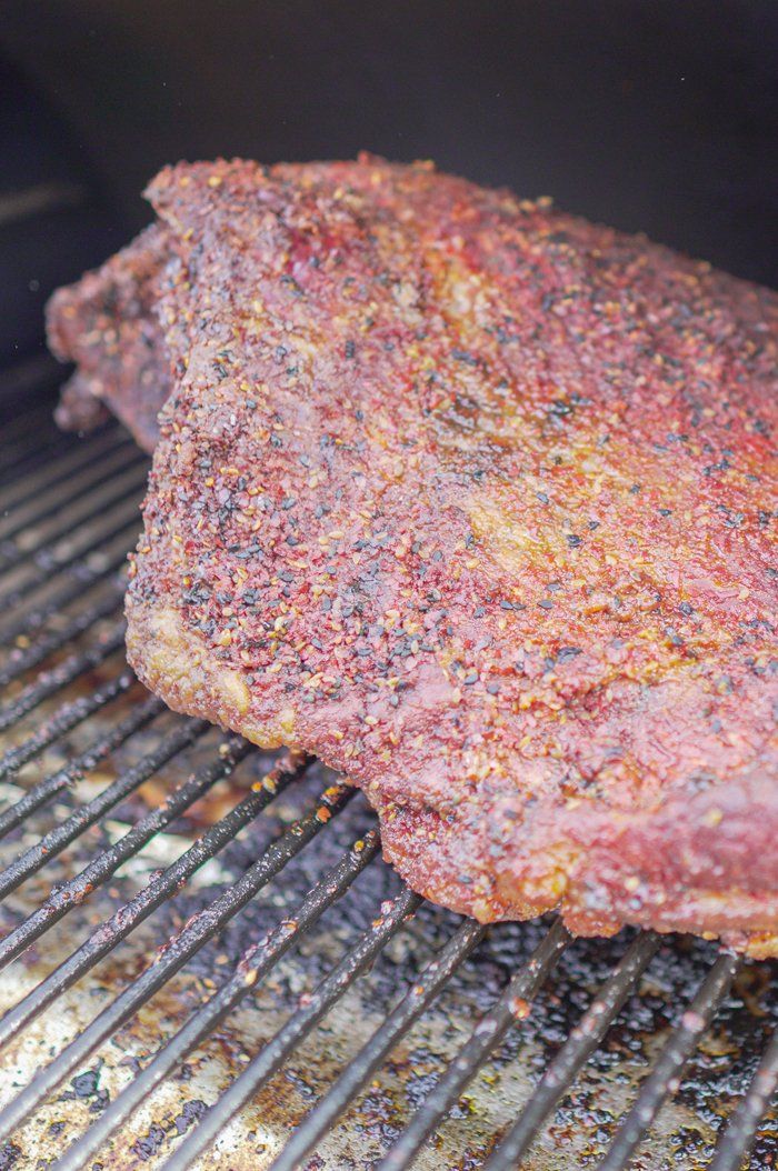 a piece of meat is cooking on the grill