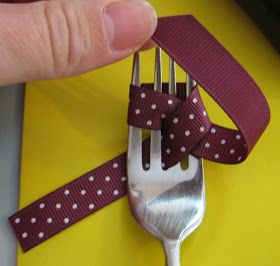 a fork with a purple ribbon around it