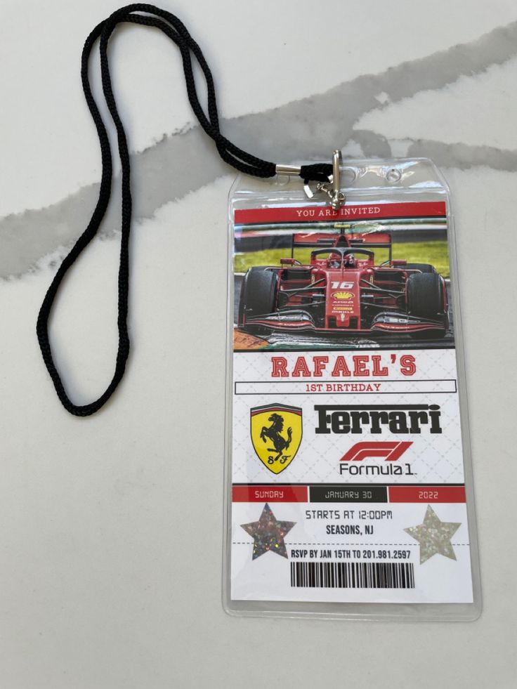 a lanyard tag with a race car on it's side and the name rafall's birthday