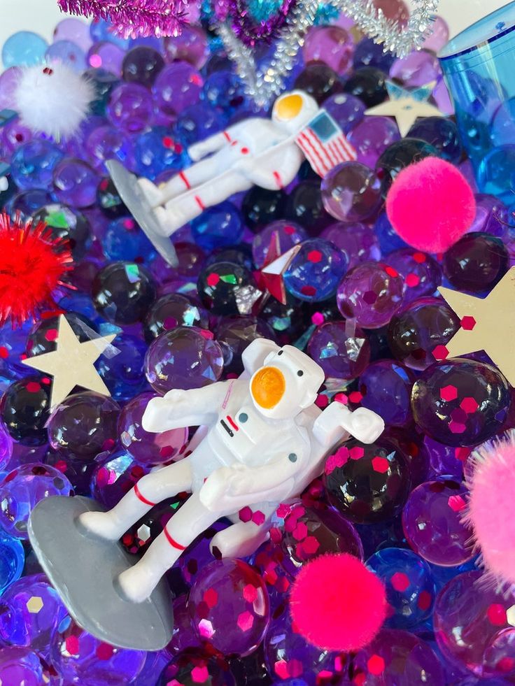 an assortment of toys and decorations are shown in the shape of astronaut's space shuttles