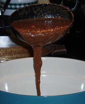 a spoon pouring chocolate into a bowl