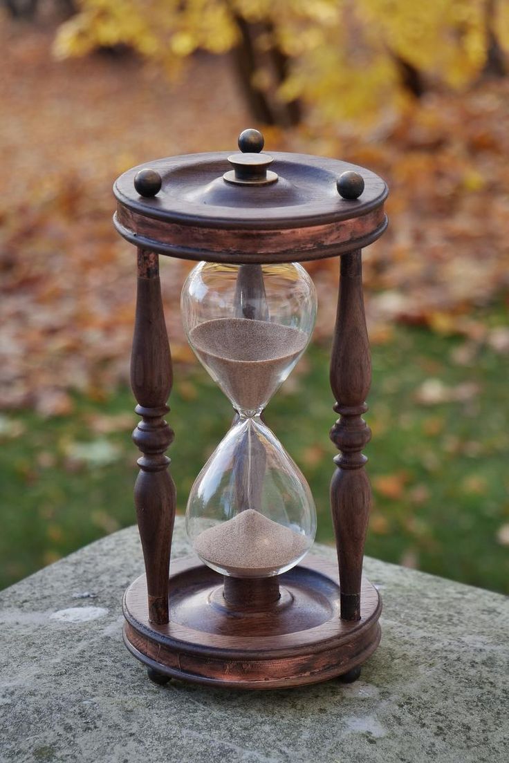 an hourglass sitting on top of a rock