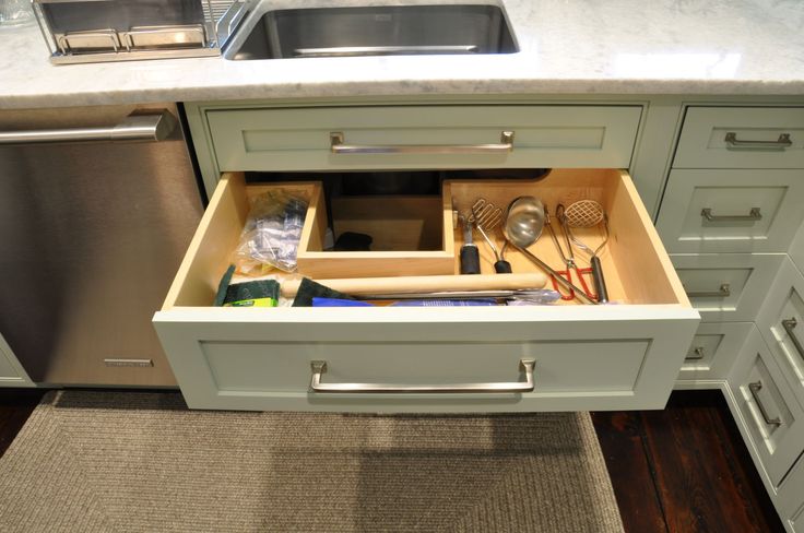 an open drawer in the middle of a kitchen counter