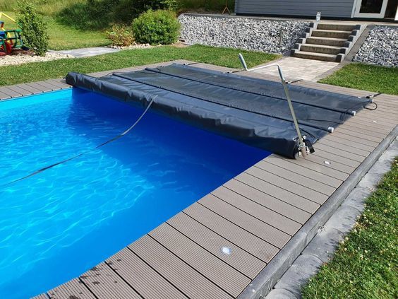 an above ground swimming pool in a backyard with steps leading up to the decking area