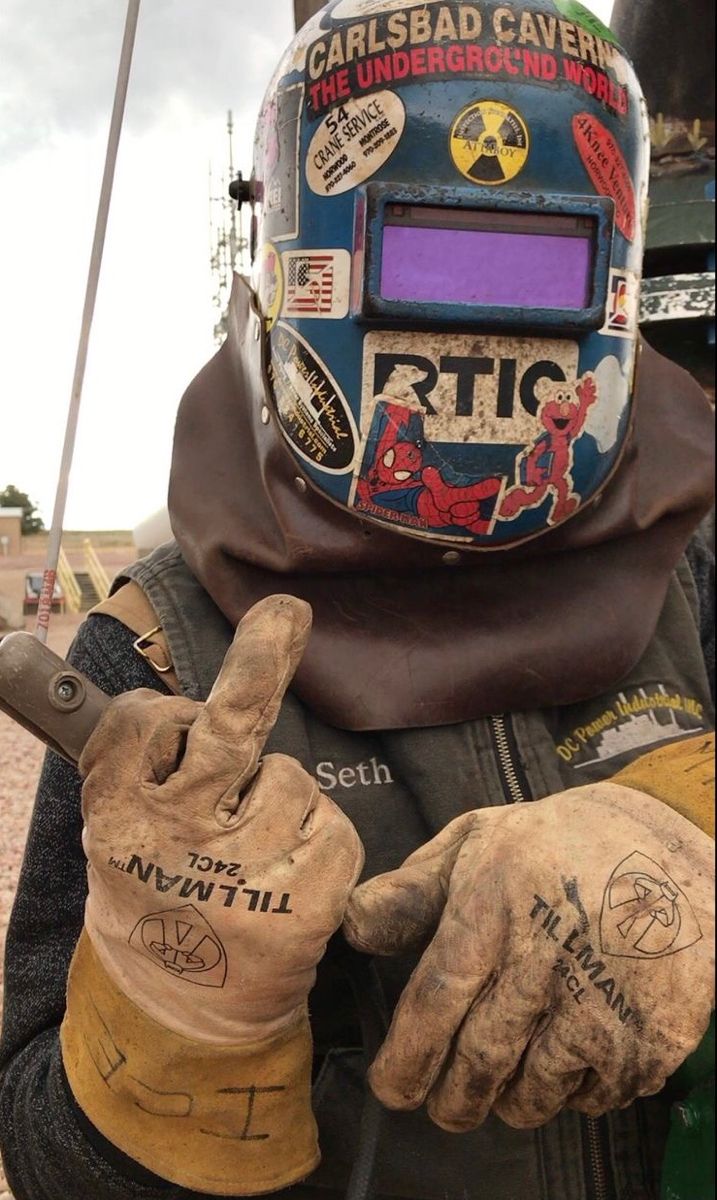 a person wearing gloves and a helmet with writing on it