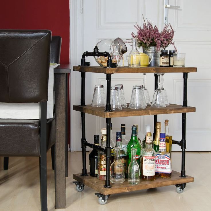 a bar cart filled with liquor bottles and glasses