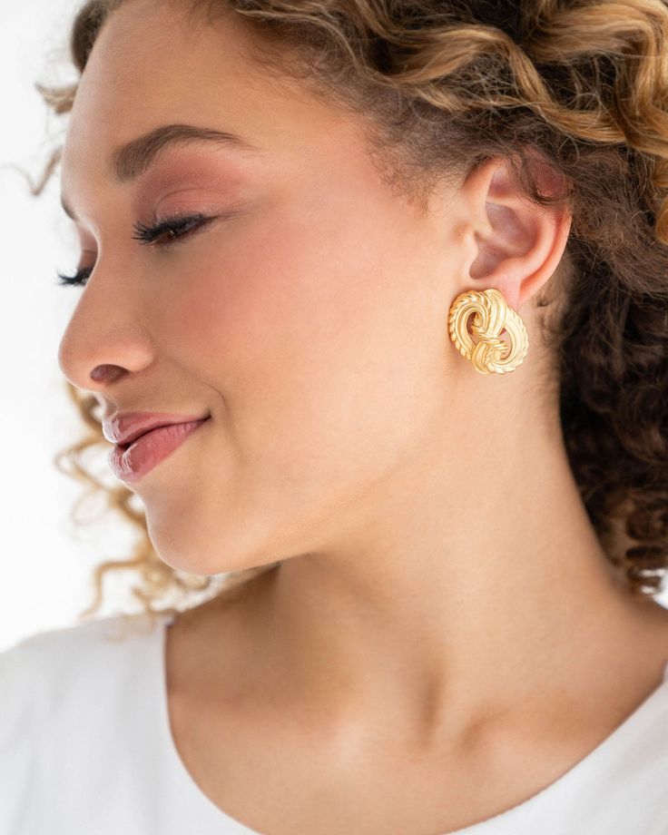 Beauty and elegance combine with our Knot Stud earrings! Crafted from gold with a classic twisted design, these timeless earrings make the perfect addition to any outfit. Add a subtle hint of sophistication with a pair of Knot Studs! Elegant Gold-tone Clip-on Hoop Earrings, Elegant Gold-tone Hoop Earrings, Gold Clip-on Wrap Earrings, Classic Gold Wrap Earrings, Elegant Gold-tone Earrings, Feminine Gold Bridal Earrings For Formal Occasions, Chic Gold Clip-on Earrings For Anniversary, Feminine Gold Plated Gold Earrings, Elegant Gold-tone Hoop Earrings For Anniversary