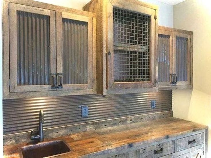 a kitchen with wooden cabinets and an old fashioned sink in the center is made out of pallet wood