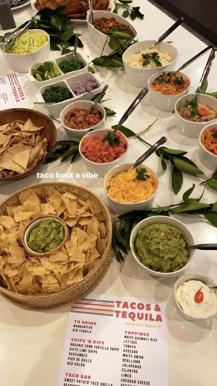 a table topped with bowls filled with different types of food and dips on top of it