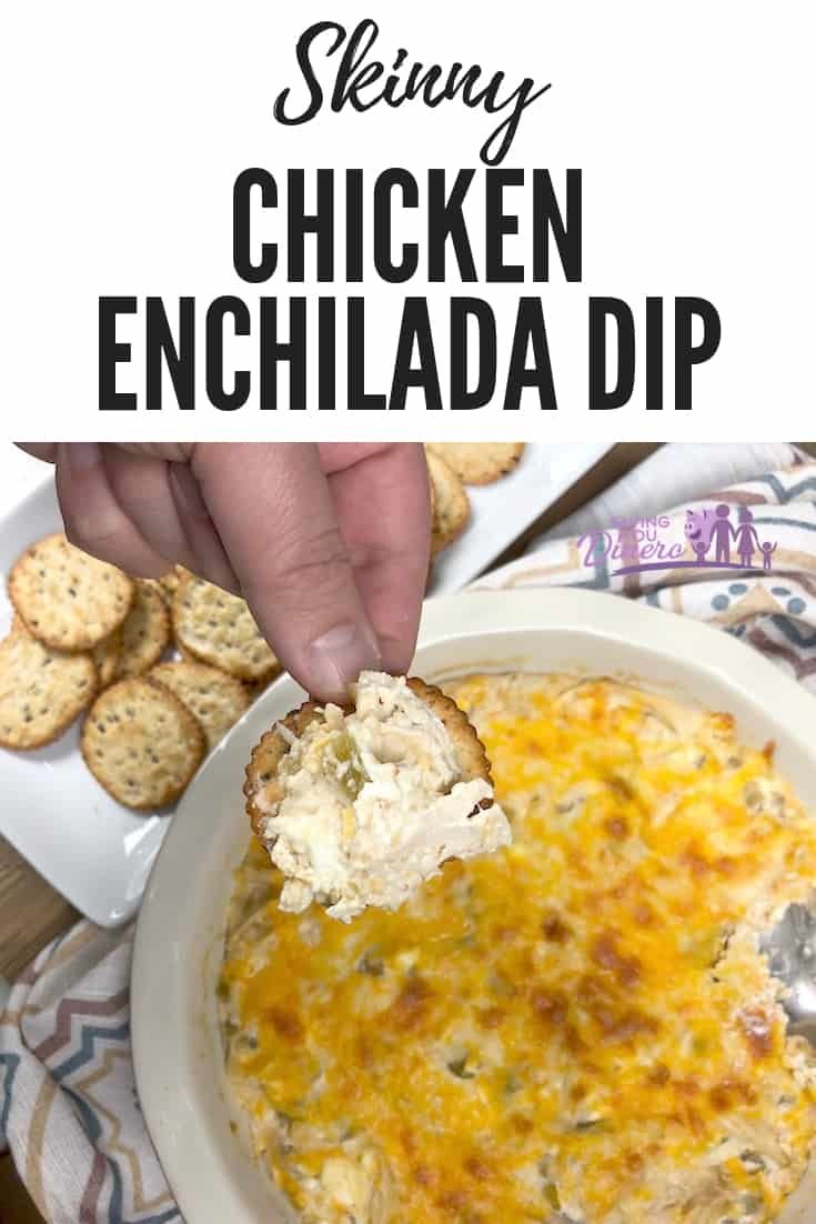 a person dipping chicken enchilada dip into a bowl with crackers on the side