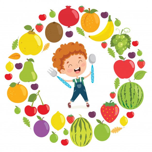 a boy is standing in front of a circle of fruits and vegetables with spoons