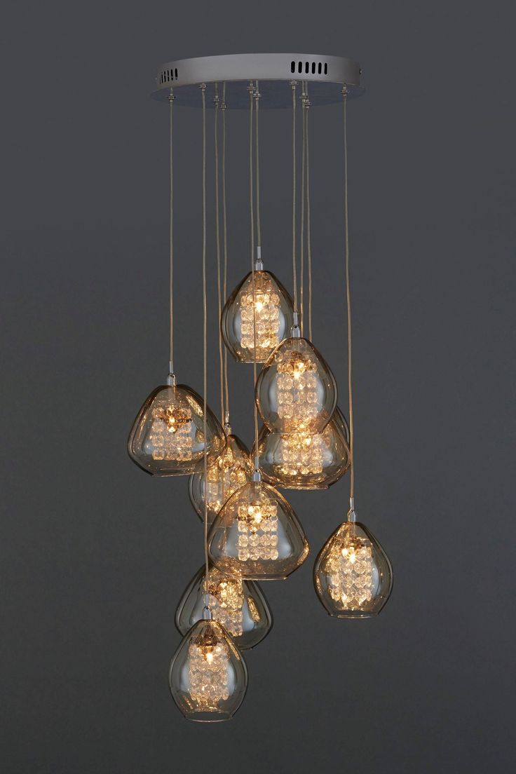 a chandelier with many lights hanging from it's sides and some bulbs on the