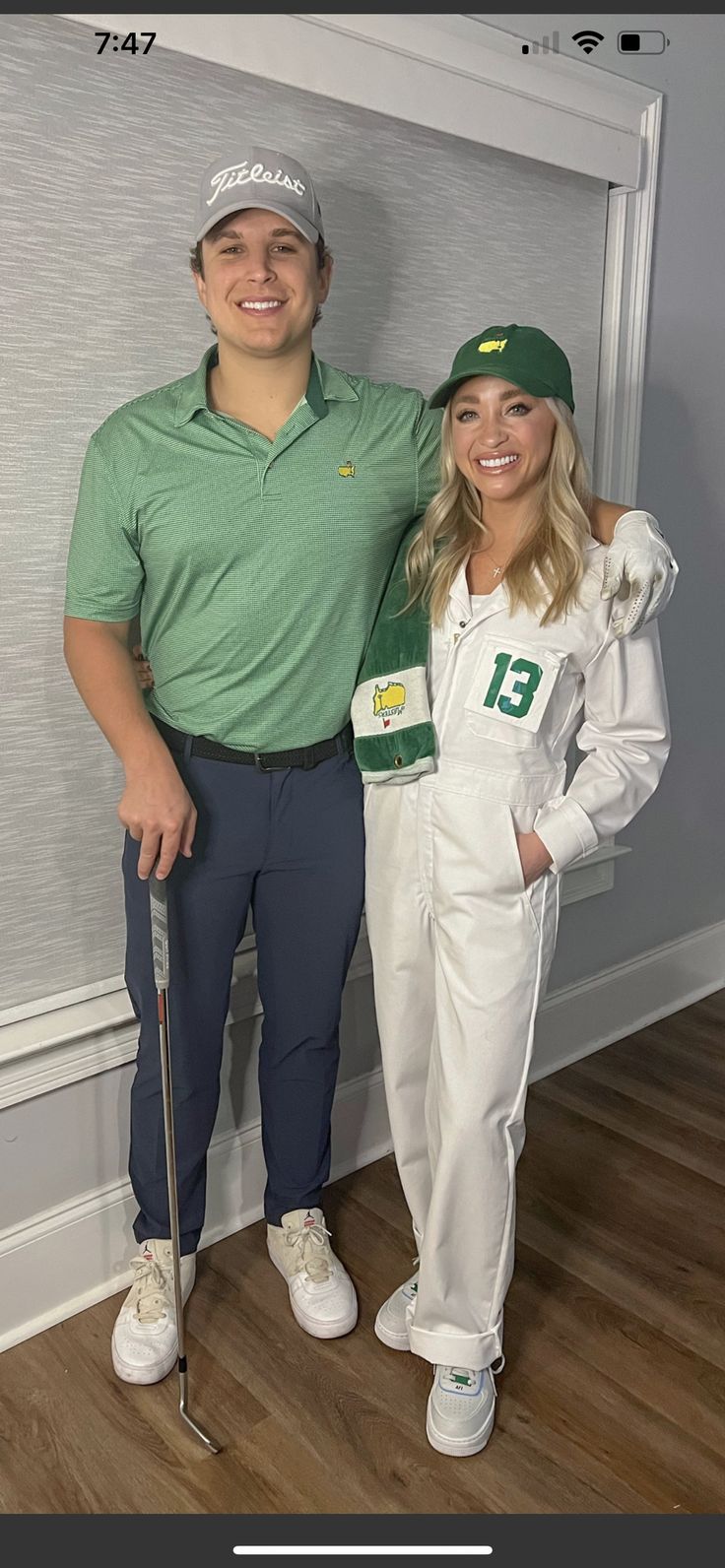 a man and woman dressed up in golf attire standing next to each other on a hard wood floor