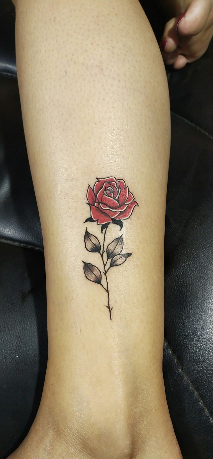 a small rose tattoo on the ankle