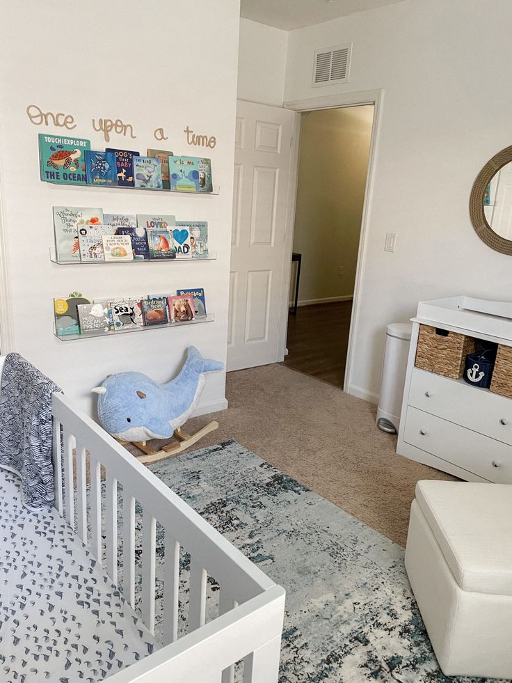 a baby's room with a crib, dresser, and bed in it