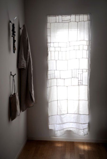 an empty room with two towels hanging on the wall and a window in the corner