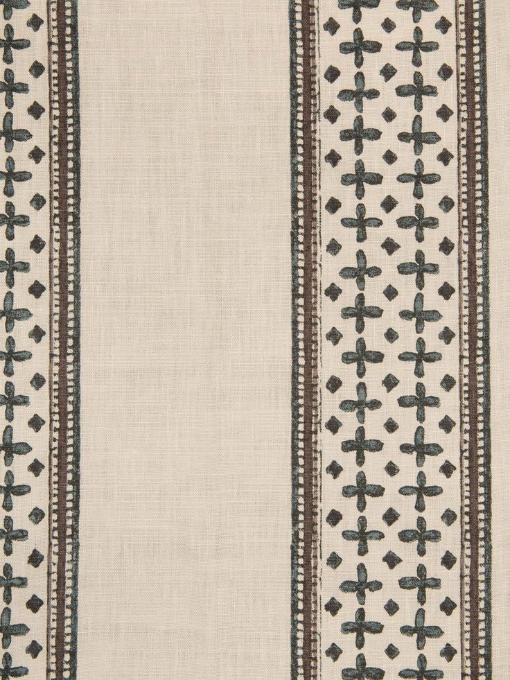 a white and black striped fabric with cross designs on it's side, in the middle