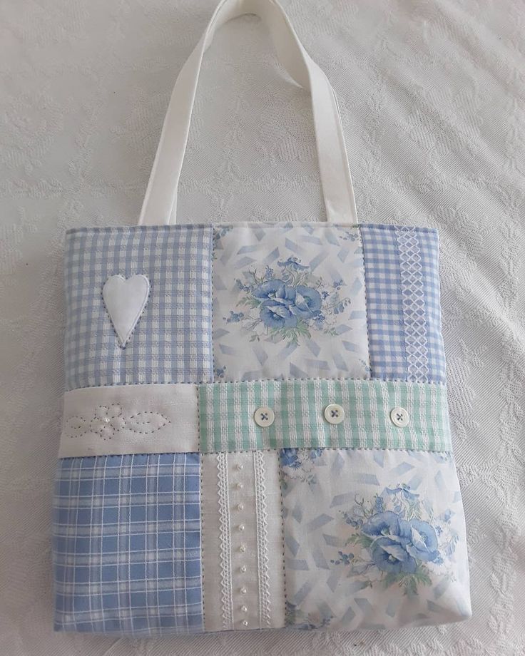 a blue and white tote bag with flowers on it