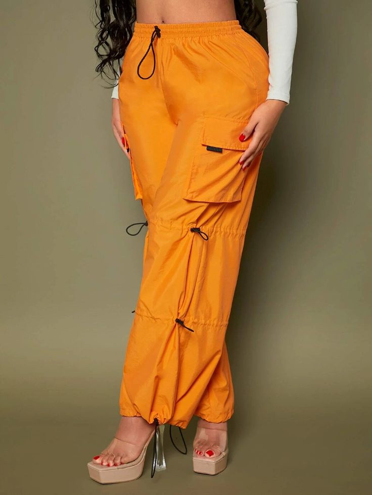 Elevate your casual style with our vibrant Orange Casual Pocket Side Cargo Pants. Crafted from high-quality woven fabric, these long-length pants offer both comfort and style. The drawstring and knot details add a touch of uniqueness, while the multiple pockets provide functionality. With a range of sizes available, you can find the perfect fit for your body. Details: Color: Orange Style: Casual Pattern Type: Plain Details: Drawstring, Knot, Pocket Length: Long Material: Woven Fabric Body: Unlin Spring Baggy Cargo Pants With Drawstring, Spring Baggy Drawstring Cargo Pants, Utility Wide-leg Pants With Drawstring, Utility Style Wide-leg Pants With Drawstring, Utility Pants With Drawstring For Fall, Fall Utility Pants With Drawstring, Trendy Ankle-length Harem Pants With Side Pockets, Spring Cargo Pants With Drawstring, Summer Cargo Pants With Drawstring