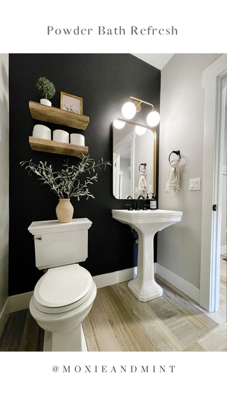 a white toilet sitting next to a sink in a bathroom under a mirror and lights