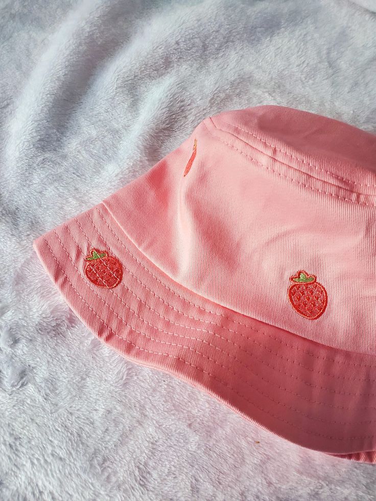 "Kawaii strawberry bucket hat! This strawberry bucket hat is a Magical Girl Bella original art and design, featuring 10 super cute strawberry drawn by my sister and then embroidered onto the hat.  Please note the pink color of the bucket hat may vary depending on lighting, computer / phone screen, and etc. Bucket Hat Inside circumference: approximately 23\" Standard adult hat size This listing has limited quantity that are ready to ship. **MORE DESIGNS AVAILABLE ON MY WEBSITE MAGICALGIRLBELLA.SQ Strawberry Vibes, Strawberry Bucket Hat, Strawberry Drawing, Pink Bucket Hat, Custom Bucket Hats, Kawaii Strawberry, Embroidered Bucket Hat, Pink Strawberry, Cute Strawberry