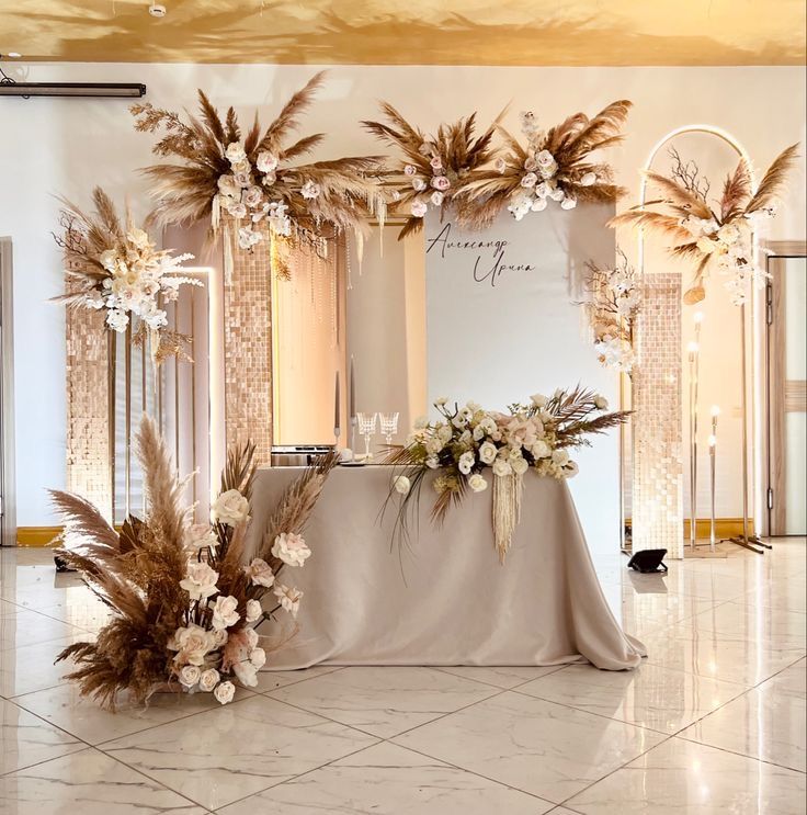 the table is decorated with flowers and feathers