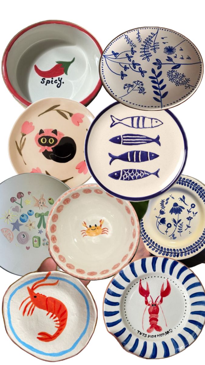 many plates with different designs are stacked on top of each other in the shape of fish and lobsters