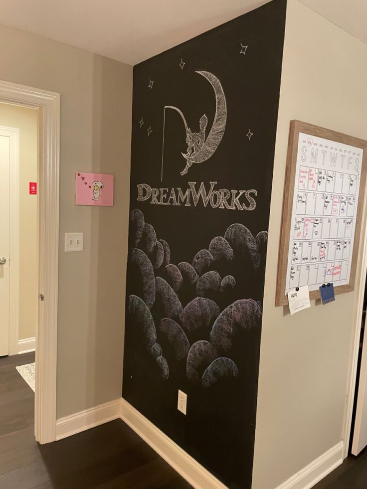 there is a chalkboard with the words dream works written on it in front of a door