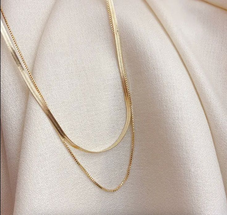 This essential necklace is a must-have for any fashion-forward individual. With its layered design and herringbone pattern, it adds a touch of uniqueness to any outfit. Stand out from the crowd and elevate your style with this one-of-a-kind accessory. Details: Stainless Steel, 18K Gold, waterproof + tarnish resistant, hypoallergenic Gold Collar Necklace, Gold Snake Chain, Double Layer Necklace, Herringbone Chain, Herringbone Necklace, Snake Necklace, Gold Necklace Set, Gold Choker Necklace, Gold Snake