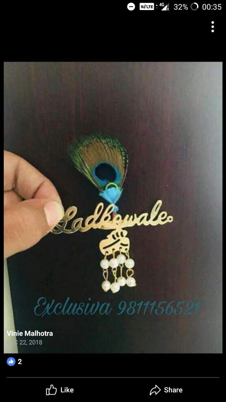 someone is holding a peacock brooch with the name cadillace on it, and there is