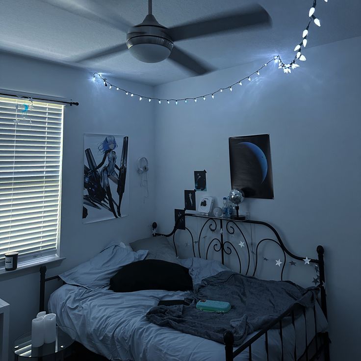 a bed room with a neatly made bed and a ceiling fan hanging from the ceiling